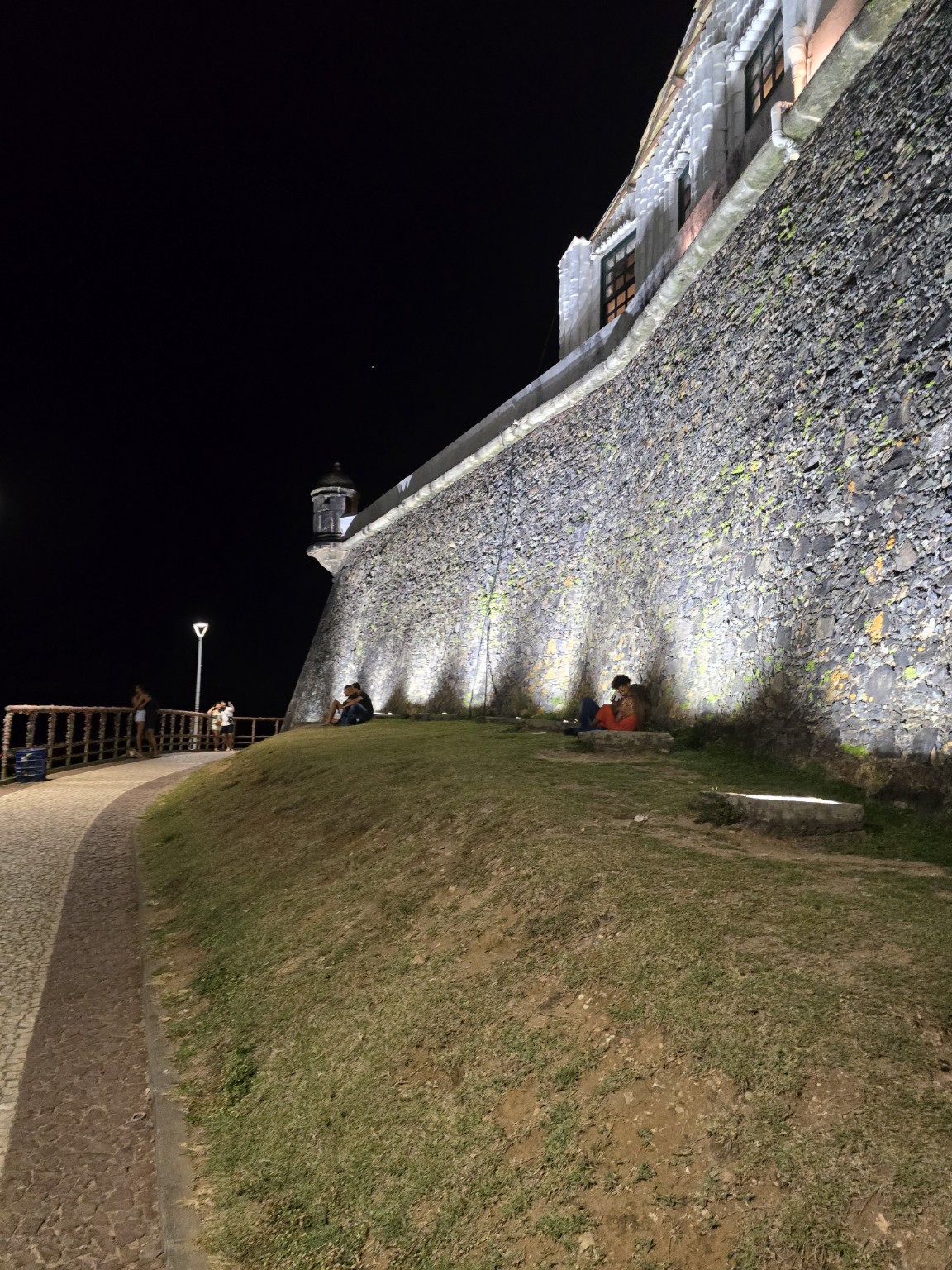 Illuminated historic stone wall in Salvador at night; an example of the city's historic fabric, not the program project building
